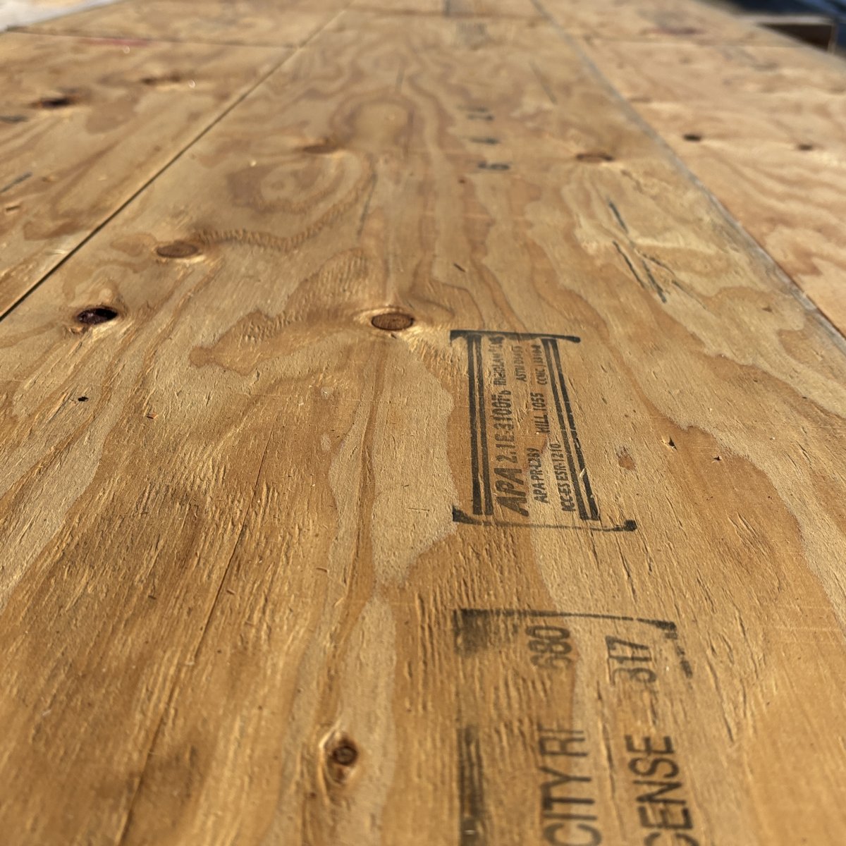 Close-up angled view of wood grain texture on 1 3/4 inch by 14 inch LVL showing layered veneer structure