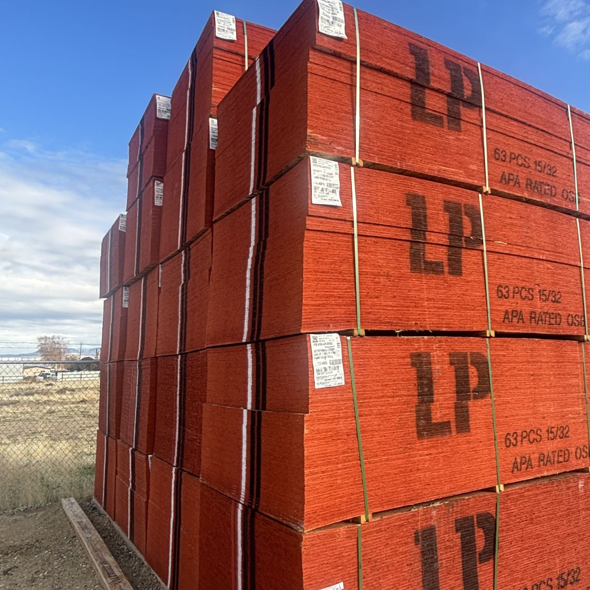 Large stacks of 15/32 inch 4x8 OSB sheathing stored on platforms at Boise lumberyard