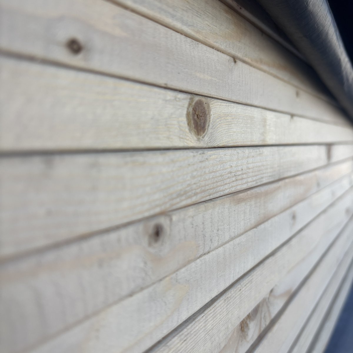 Close-up wood grain of 1x #2 kiln-dried whitewood board side grain at Dynamic Lumber Solutions yard