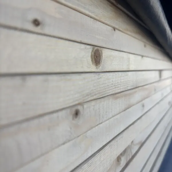 Close-up wood grain of 1x #2 kiln-dried whitewood board side grain at Dynamic Lumber Solutions yard