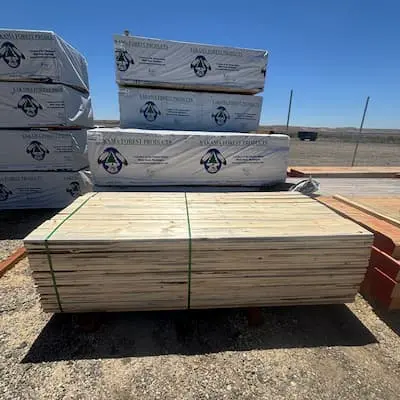 An opened bunk of 1x6 economy whitewood boards on yard racks, showing the clean and usable condition of the lumber inside the pack.