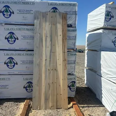 A side-by-side vertical alignment of 1x6 utility whitewood boards highlighting the natural variations permitted in #4 grade lumber.