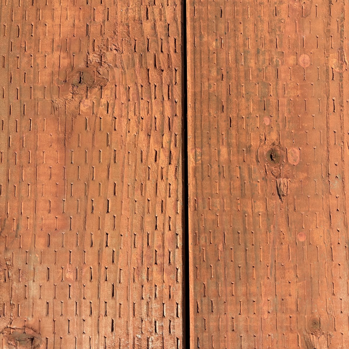 2x pressure-treated #2 fir lumber for ground contact, brown tone, incised surface at Dynamic Lumber Solutions yard