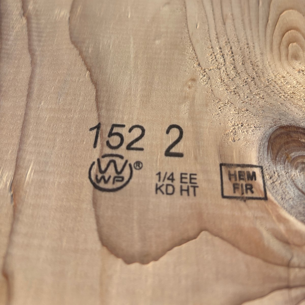 Grade stamp on 2×10 #2 kiln-dried Hem-Fir lumber showing grade and mill identification