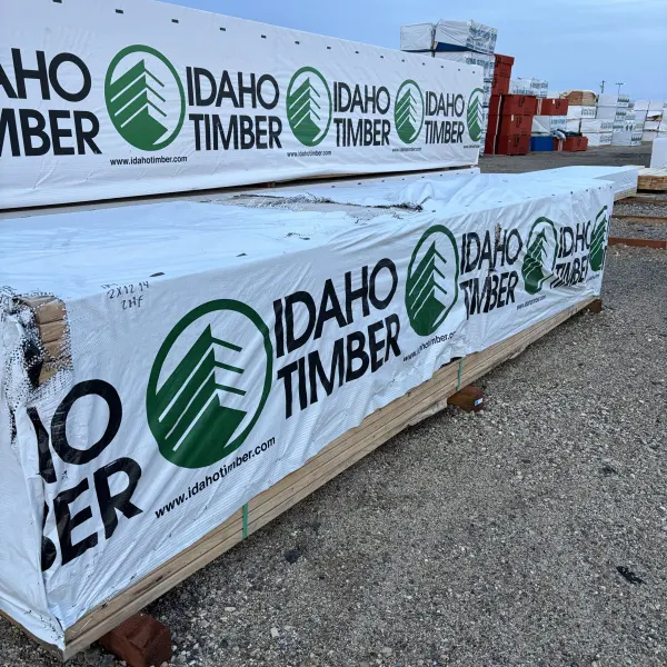 Angled view of 2×12×14′ #2 kiln-dried Hem-Fir lumber with wider Boise lumberyard in background