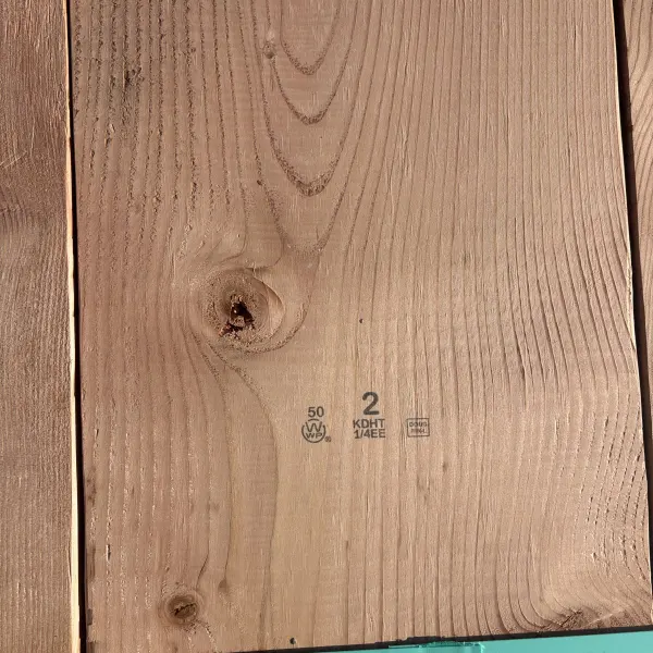 Grade stamp on 2×12 #2 kiln-dried Douglas Fir lumber showing grade and mill identification