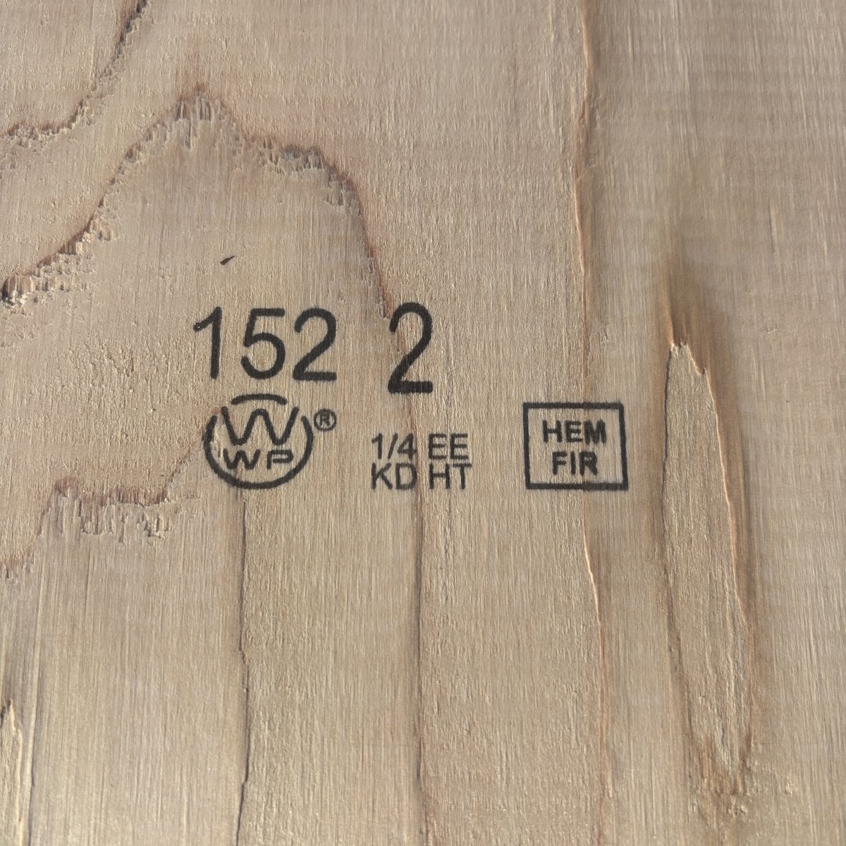 Grade stamp on 2×12 #2 kiln-dried Hem-Fir lumber showing grade and mill identification