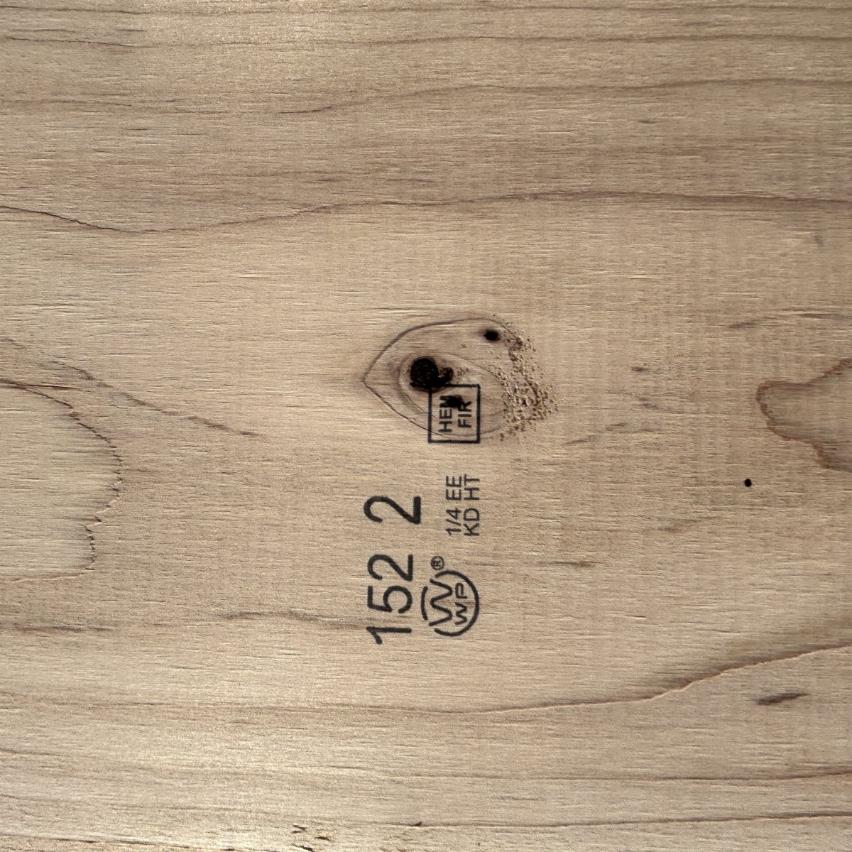 Grade stamp on 2×12 #2 kiln-dried Hem-Fir lumber showing grade and mill identification