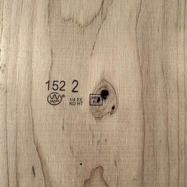 Grade stamp on 2×12 #2 kiln-dried Hem-Fir lumber showing grade and mill identification