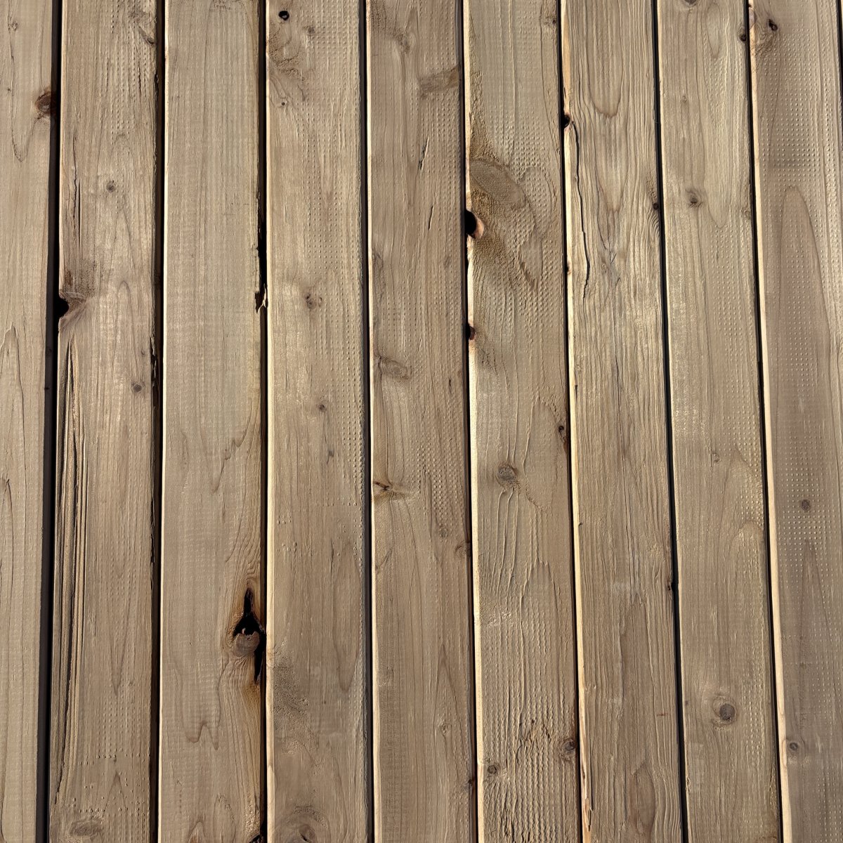 Top-down view of Hem-Fir wood texture on 2×4 #2 kiln-dried lumber showing grain pattern and surface detail