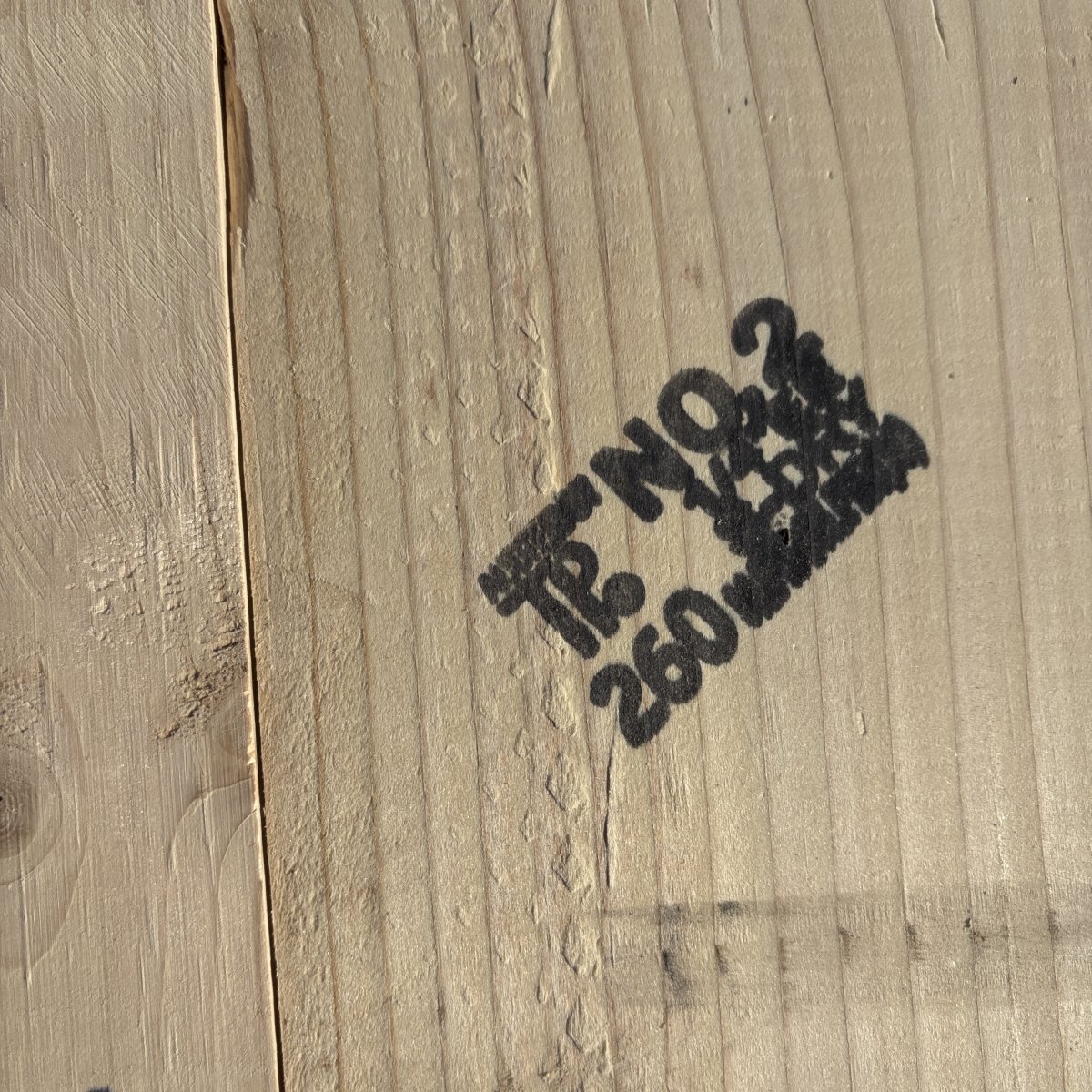 Grade stamp on 2×6 #2 kiln-dried Hem-Fir lumber showing grade and mill identification