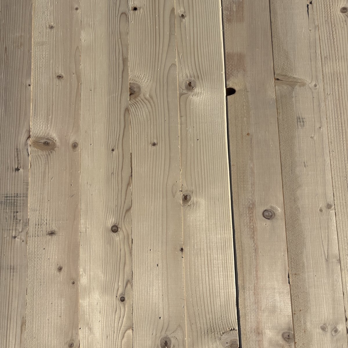 Top-down view of Hem-Fir wood texture on 2×6 #2 kiln-dried lumber showing grain pattern and surface detail