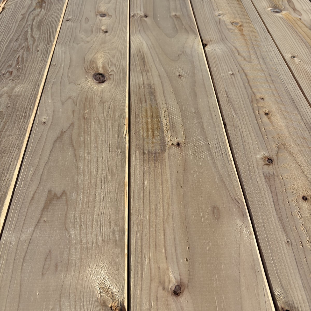 Close-up angled view of Hem-Fir wood grain on 2×8 #2 kiln-dried lumber showing natural texture and grain pattern