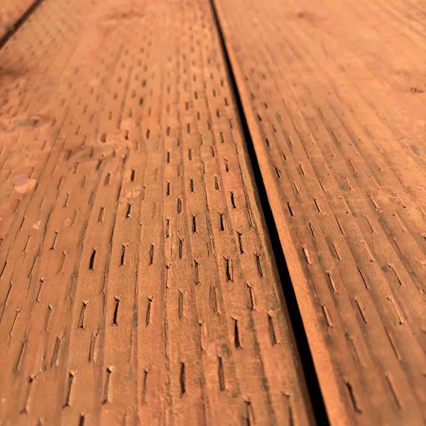 6x pressure-treated #2 fir lumber for ground contact, brown tone, incised surface at Dynamic Lumber Solutions yard