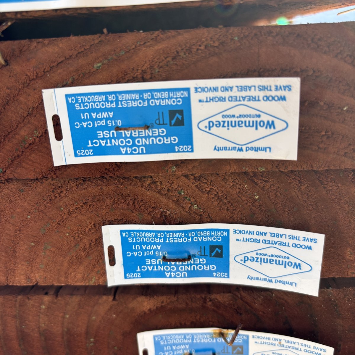 End grain of 2x ground contact pressure-treated #2 fir lumber showing CAC treatment